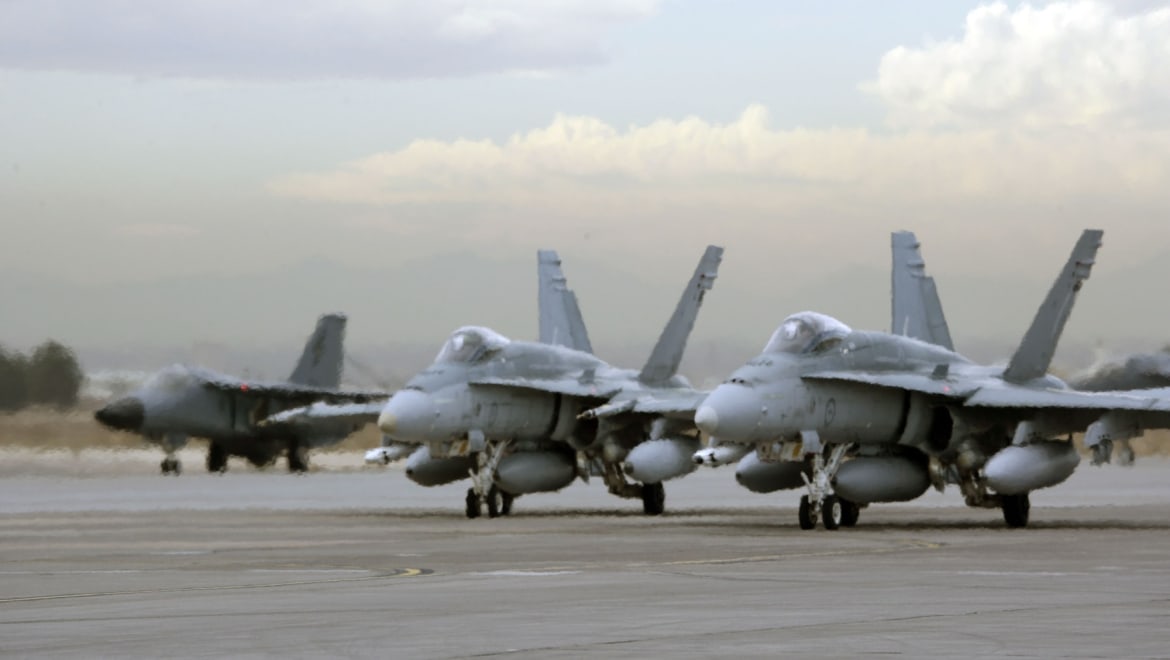 A Royal Australian Air Force F-111 from Number 1 Squadron and two F/A-18s from Number 3 Squadron taxi out to the runway to take part in Exercise Red Flag at Nellis Air Force Base, Nevada.Personnel from Royal Australian Air Force (RAAF) Base Amberley and RAAF Base Williamtown have participated in three weeks of intensive training in the United States of America as part of Exercise RED FLAG 06.Up to 270 personnel, six F-111s and seven F/A-18 Hornets have deployed to the United States for advanced training at one of the world's best tactical combat training facilities.Red Flag provides significant training objectives for RAAF aircrew as it offers complex air combat scenarios involving coalition fighter, strike and surveillance assets.Deployment for Red Flag began in stages from 26 January 06, with exercise flying running from 6 to 17 February.