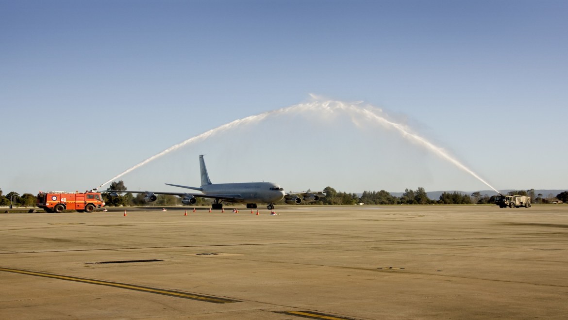 Two fire trucks form a water bridge to welcome home the final Royal Australian Air Force (RAAF) Boeing 707 to RAAF Base Richmond upon return from Exercise Pitch Black 08, on June 27, 2008. AFIR: 000-188-905